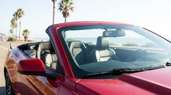 Dash cam mounted on the windshield of a car rental driving along a California coastline