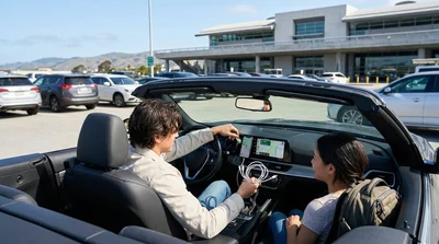 Driver plugging a charging cable into a car dashboard at a San Francisco car rental