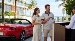 Red convertible car rental driving along a sunny beach road with palm trees in Miami