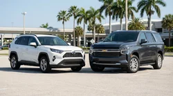 A modern SUV parked on a sunny coastal road with palm trees during a Florida car hire