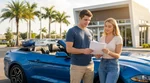 Young adult driving a car rental along a sunny palm-lined highway in Florida