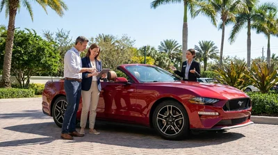 White convertible car rental driving along a scenic coastal highway with palm trees in Florida