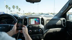 Driver connecting a smartphone to the digital dashboard screen inside a Texas car rental