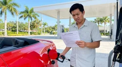 Person pumping gas into a modern car rental at a sunny Florida gas station with palm trees