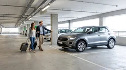 Rows of parked vehicles in a multi-level car rental garage at JFK Airport in New York