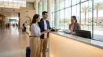 Customer presenting travel documents to an agent at a Las Vegas car rental counter