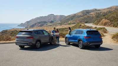 Silver 4WD car rental navigating a dusty off-road trail in the California desert