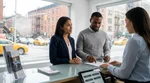 Customer reviewing paperwork with an agent at a New York car hire counter
