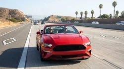 White car rental driving in a dedicated HOV lane on a sunny California highway