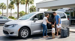 Child seat securely installed in the back of a car rental parked under palm trees in Florida