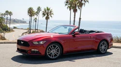 A modern car hire driving along a scenic coastal highway in sunny California