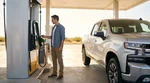 Person using a credit card at a gas pump to fuel a car rental in Texas