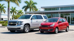A white SUV and a blue compact car parked side by side at a car rental lot under palm trees in Florida