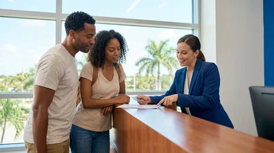 Driver presenting a driving licence to an agent at a car hire counter in Florida