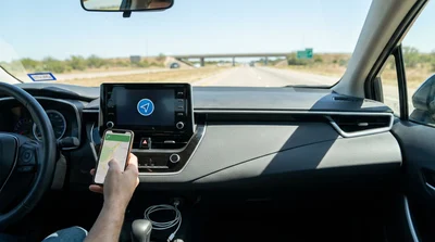 Close-up of a USB cable connected to a smartphone on the dashboard of a Texas car rental
