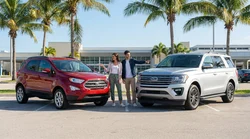 Compact and standard SUVs parked next to each other on a sunny Florida coastal road for a car rental