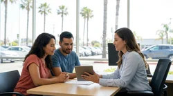 Person handing over car keys at a car rental counter in California