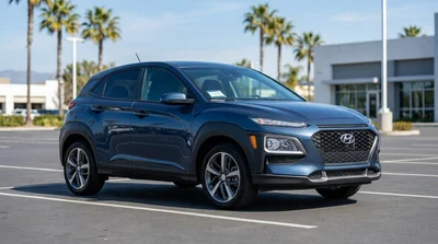 White compact SUV car rental driving along a scenic coastal highway in California