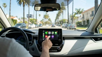 Driver touching an Apple CarPlay dashboard screen inside a Los Angeles car rental