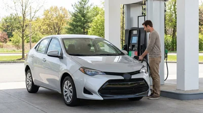 A person filling a car rental with gas at a fuel pump in Pennsylvania