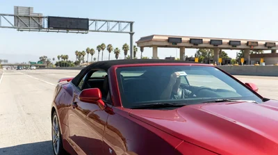 Dashboard view from inside a car rental approaching an electronic toll plaza in California