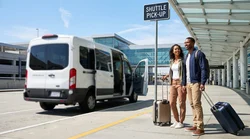 A car hire shuttle bus parked at the curbside pick-up zone outside San Francisco airport