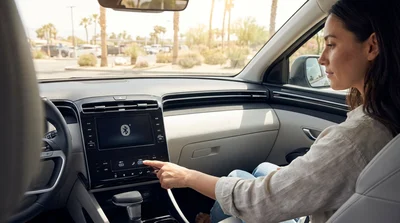 Modern car rental dashboard showing USB ports and a Bluetooth screen with a Las Vegas street in the background