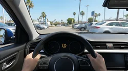 Close-up of an illuminated tyre pressure warning light on the dashboard of a California car rental