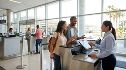 Travelers with luggage waiting at a shared car hire counter inside Miami Airport