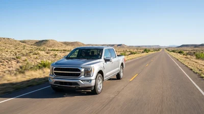 Modern white car rental driving along a scenic desert highway in Texas