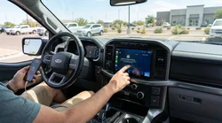 Driver touching an Apple CarPlay dashboard screen inside a Texas car rental