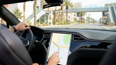 Driver using a sat nav screen inside a car rental on the Las Vegas Strip
