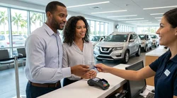 Close up of a traveler handing a credit card to an agent at a car rental desk in Miami