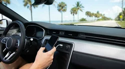 Smartphone connected to a USB-C dashboard charging port inside a Florida car rental