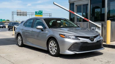 Person driving a car rental through an electronic toll plaza on a Pennsylvania highway
