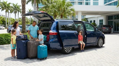 Five people loading luggage into a spacious SUV car rental parked on a sunny street in Miami
