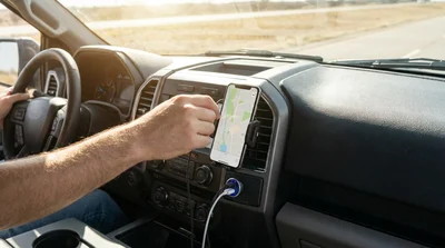Dashboard of a Texas car rental showing a smartphone secured in a mount and connected to a USB charger