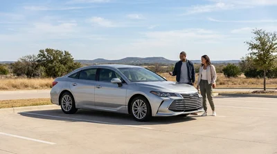 Silver full-size car rental driving on a sunny desert highway in Texas