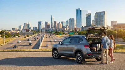 Silver compact car rental parked on a sunny downtown street in Texas