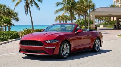 Red convertible car rental driving on a sunny palm-lined coastal road in Florida
