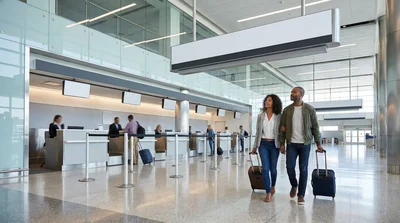 Hola car rental desk with branded signage inside the JFK airport terminal in New York