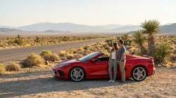 A white car rental driving along a scenic desert highway outside Las Vegas