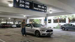 Rows of vehicles parked in numbered bays inside a Las Vegas car hire center