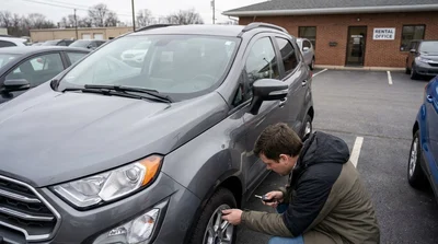 Close up of a person checking the tires and wipers of a car rental in Pennsylvania