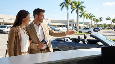 Driver steering a modern car rental along a sunny coastal highway with palm trees in Florida