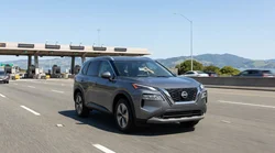 Silver car rental passing through a bridge toll plaza in San Francisco