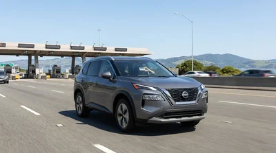Silver car rental passing through a bridge toll plaza in San Francisco