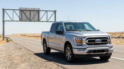 White car rental driving on a scenic highway in Texas near the state line