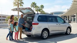 Family loading suitcases into a spacious 7-seater car rental outside the Orlando airport terminal