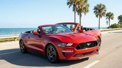 A white car rental driving along a sunny coastal highway in Florida